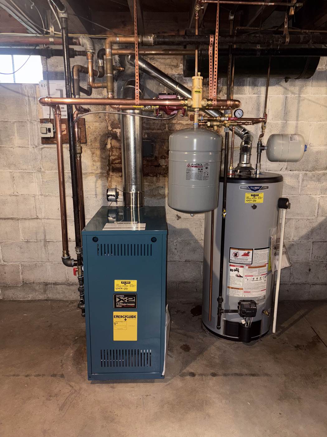 US Boiler gas boiler with copper near-boiler piping and an expansion tank, installed by Tom Falk.