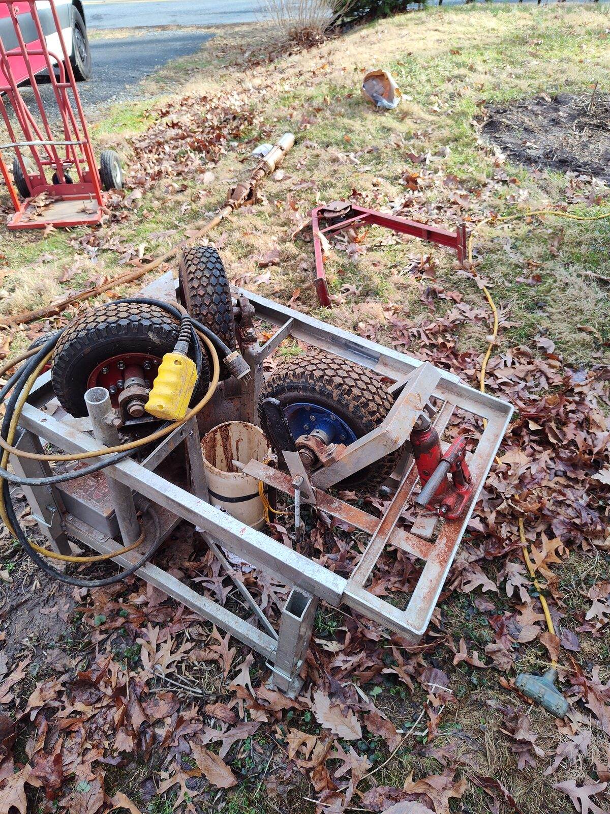 Tom Falk's wheeled hydraulic well-pump puller set up on a lawn to pull a submersible pump from a well.