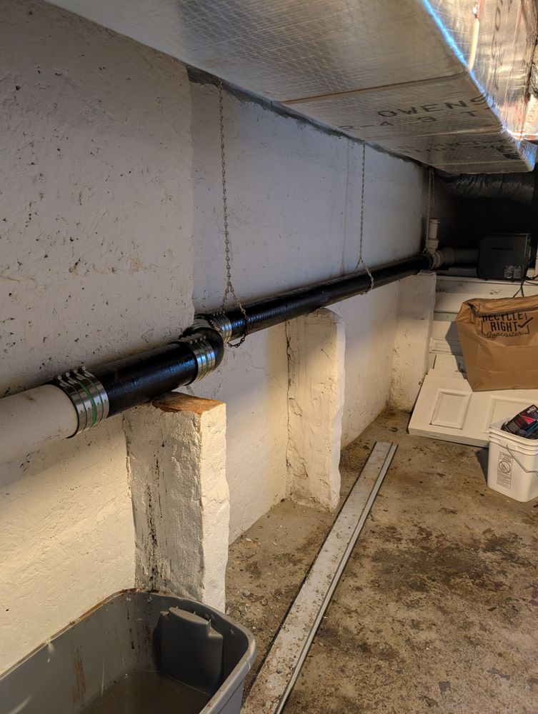 The new drain line back in place in the Lancaster City building's basement after the cracked cast iron section was cut out.